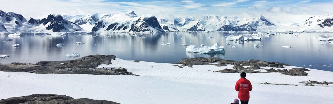 two person standing on snow field