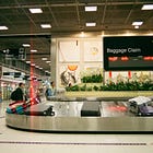 You're Probably Paying Too Much to Check a Bag. Here's the Fix.