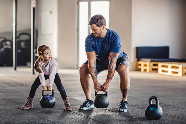She's gonna be strong like daddy Father doing his training with kettlebells in gym while his little daughter supporting him. Children are strong stock pictures, royalty-free photos & images She's gonna be strong like daddy Father doing his training with kettlebells in gym while his little daughter supporting him. Children are strong stock pictures, royalty-free photos & images