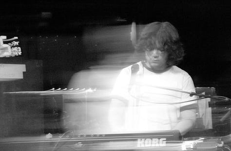 Black-and-white photos of each member of the Tweedy band performing live