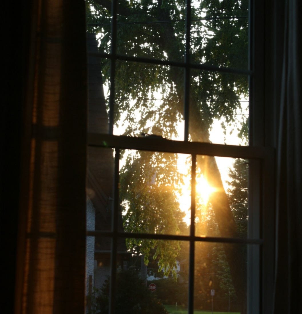 The Night I Said I Can't: sun shining through a window into a dark room One Year After Losing Two Friends: picture of a sunset shining through the windows of a dark room
