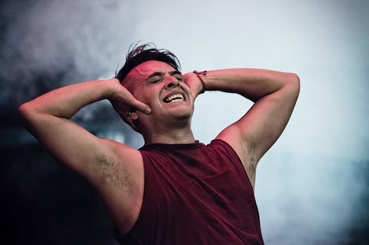 Man screaming with his hands on his head Man screaming with his hands on his head