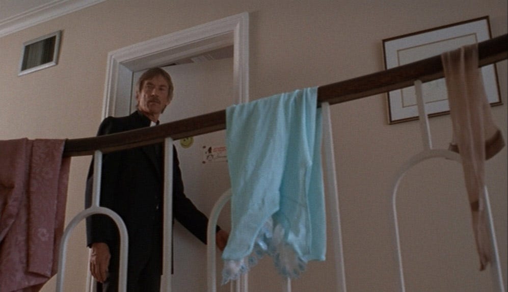 Father Moody, eyeing the garments flung upon the banister, prepares to enter one of the girls' bedrooms.