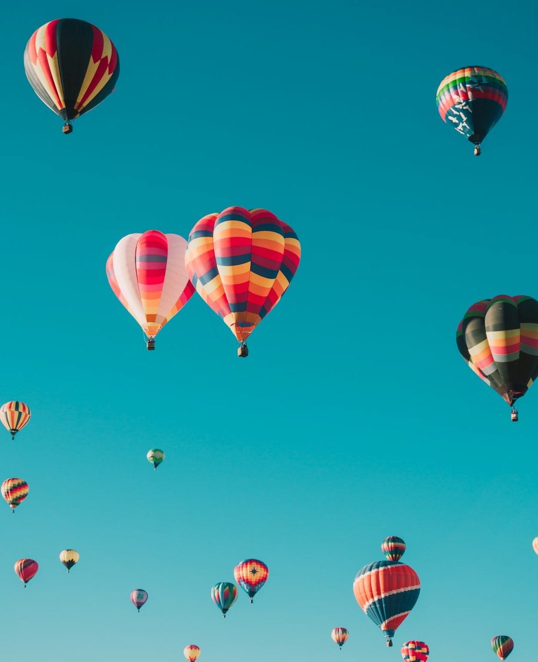 assorted hot air balloons flying at high altitude during daytime