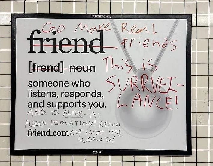 Vandalized subway ad for friend.com: The dictionary definition of "friend" is crossed out and overlaid with red graffiti reading "Go make Real friends." The text "AND IS ALIVE! - AI FUELS ISOLATION! REACH out into the WORLD!" is added to the definition, and "This is SURVEILLANCE!" is scrawled over the image of a pendant.