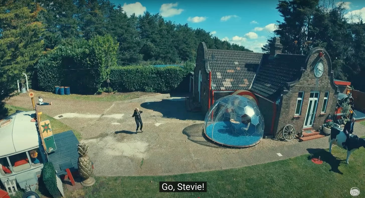 Stevie Martin hops as though using an invisible jump rope across the Taskmaster lawn.