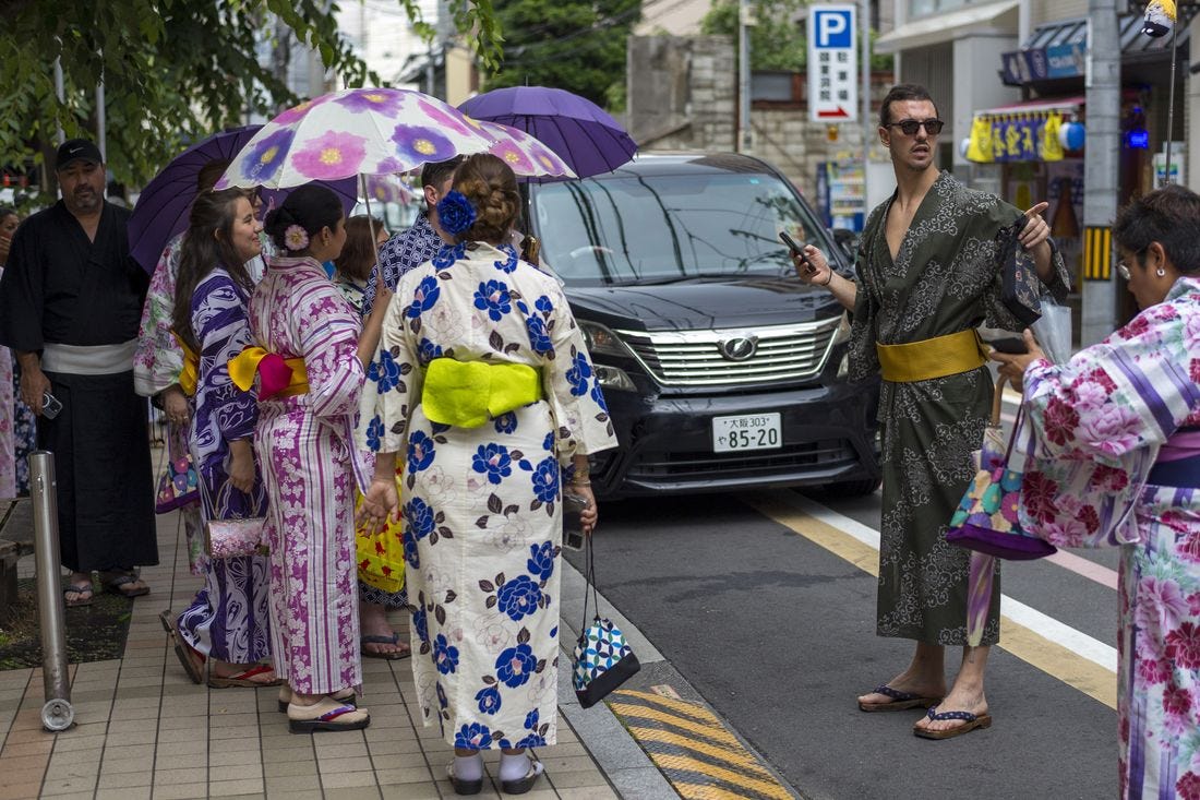 Tourists dressed in traditional Japanese kimonos in Kyoto, Japan. Tourists dressed in traditional Japanese kimonos in Kyoto, Japan.