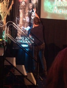 Jensen signs the banner