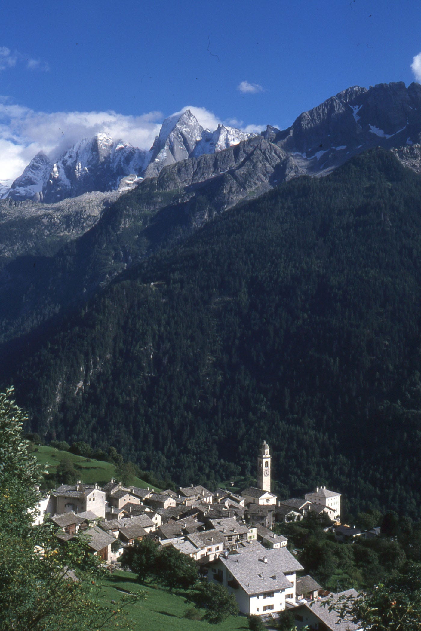 Rocky mountains, pine trees, village with church steeple