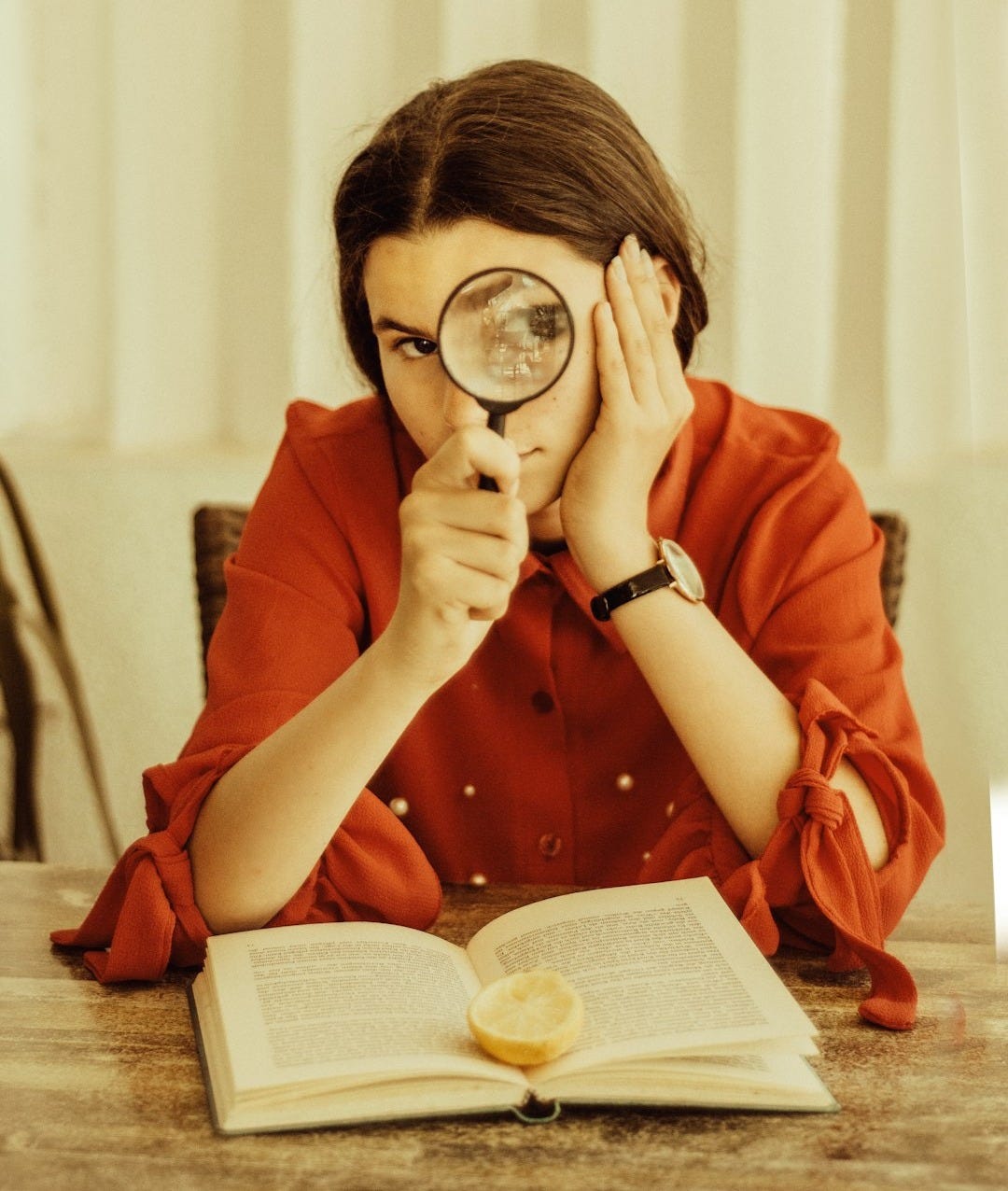 woman holding magnifying glass