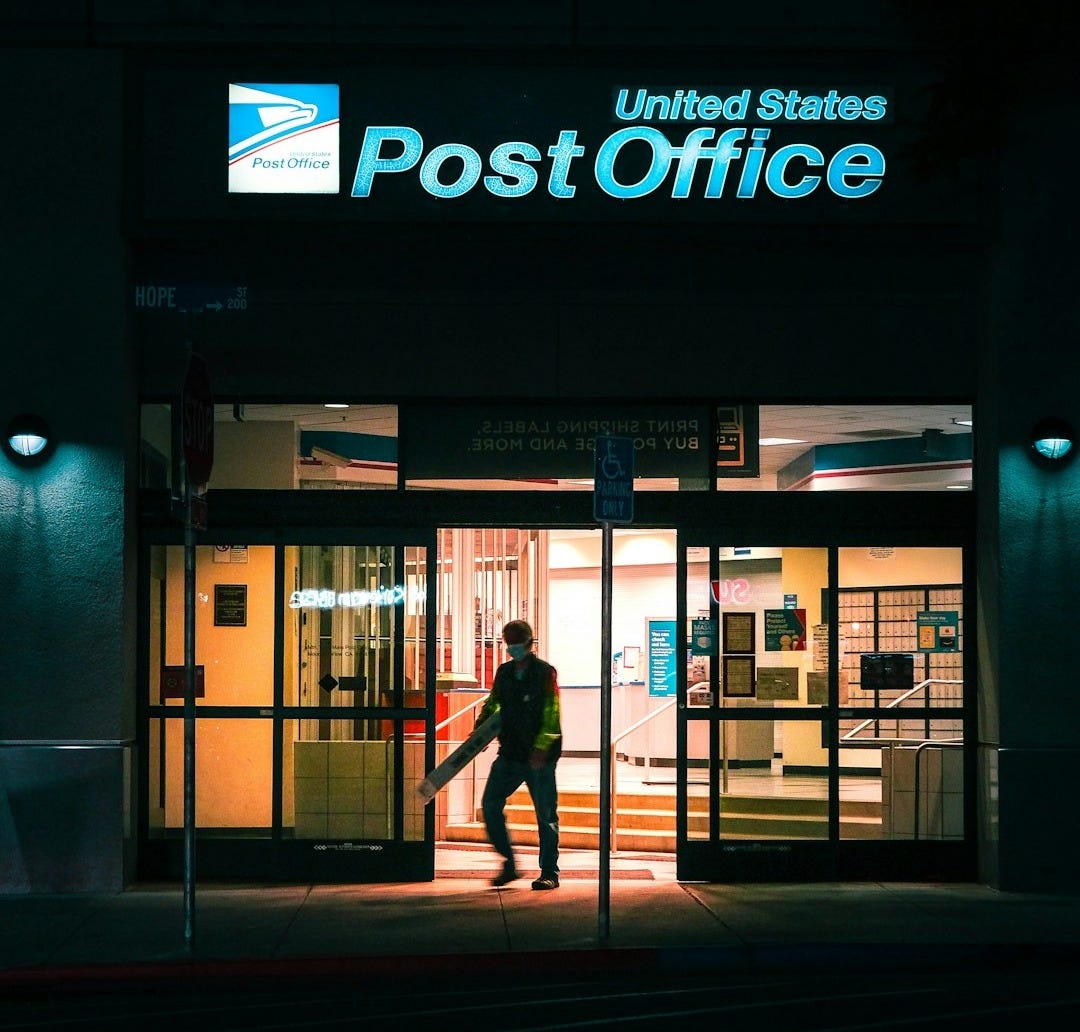 a man entering a post office at night