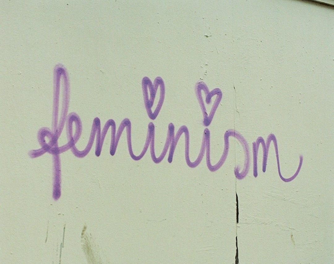 a couple of chairs sitting next to a wall a couple of chairs sitting next to a wall