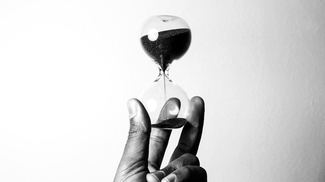 person holding hourglass person holding hourglass