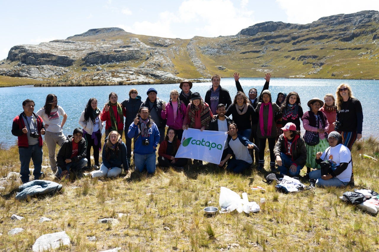 Group of people posing with CATAPA banner in front of a lake on a sunny day. Group of people posing with CATAPA banner in front of a lake on a sunny day.
