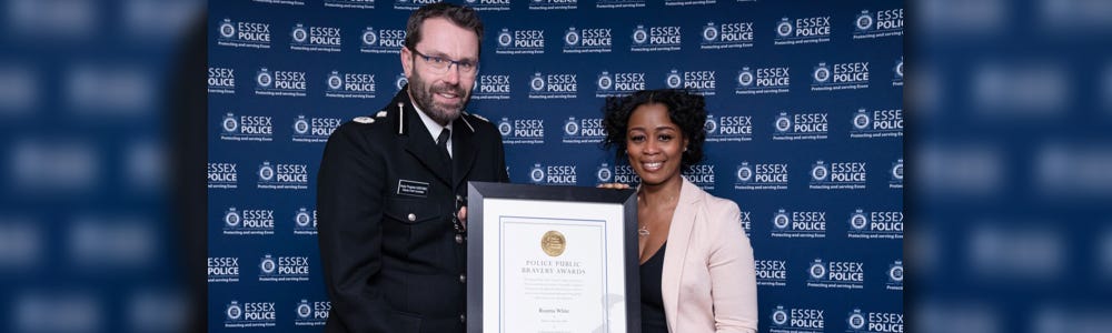 Roanna White receives her bravery award from Deputy Chief Constable Andy Prophet.