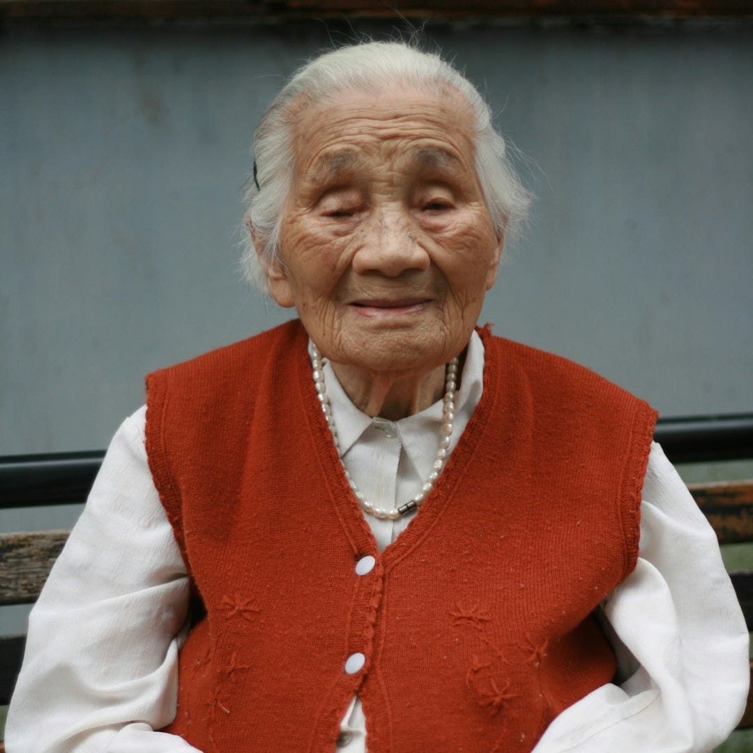 woman in red vest and white dress shirt woman in red vest and white dress shirt