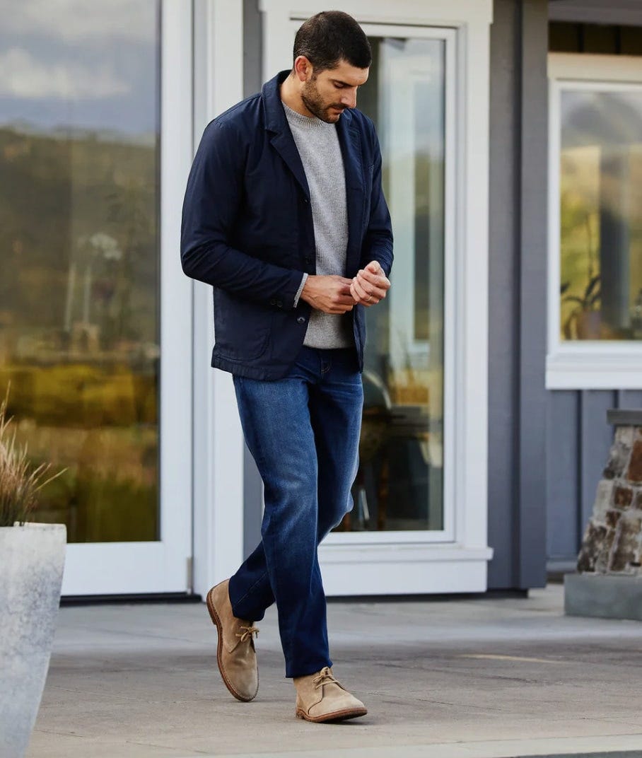 a man wears the relwen flex field blazer while walking in the summer
