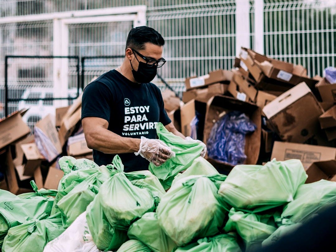a man in a black shirt and some bags a man in a black shirt and some bags