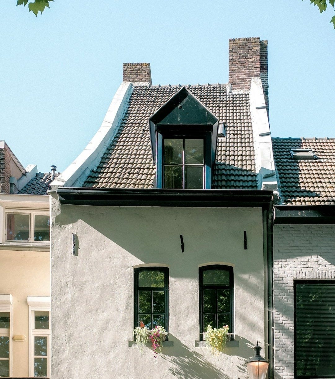A tall, old building in bright sunlight.
