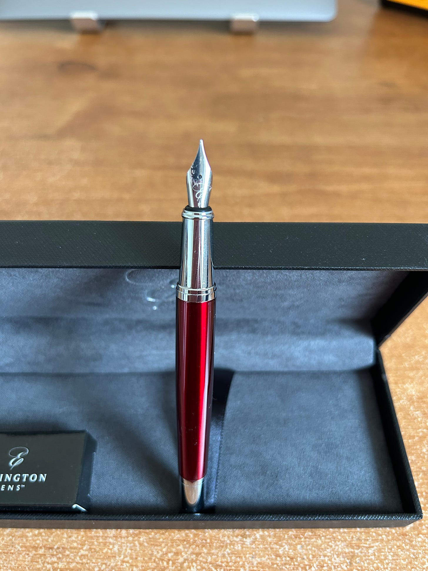 An Ellington Classic Fountain Pen in slate red standing nib up in its presentation box. Photo: Roland Millward