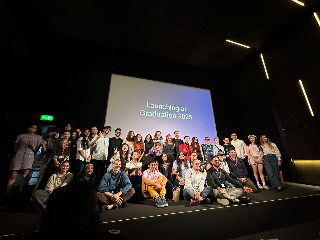 The 2024/25 Design Futures masters cohort posing on stage for a celebratory group photo at the end of their symposium. The 2024/25 Design Futures masters cohort posing on stage for a celebratory group photo at the end of their symposium.