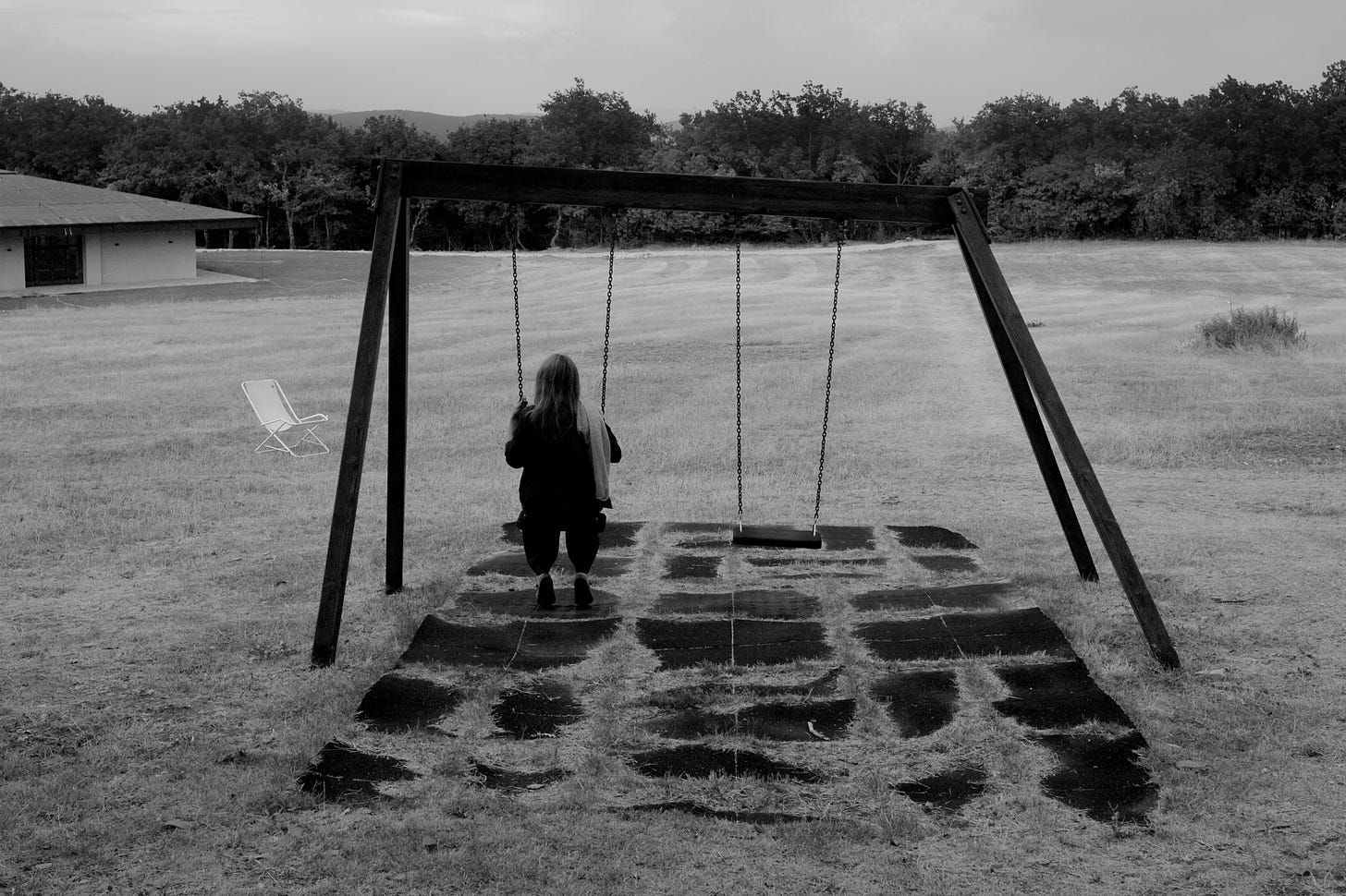 Girl sitting on swing during daytime