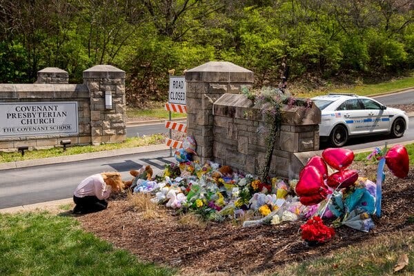 A woman prayed among flowers left at a memorial at the entrance to the Covenant School in Nashville.