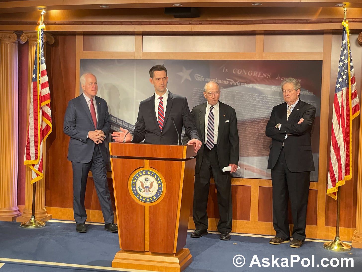 Men in suits stand behind a podium talking as stage lights shine on them © AskaPolUAPs.com Men in suits stand behind a podium talking as stage lights shine on them © AskaPolUAPs.com
