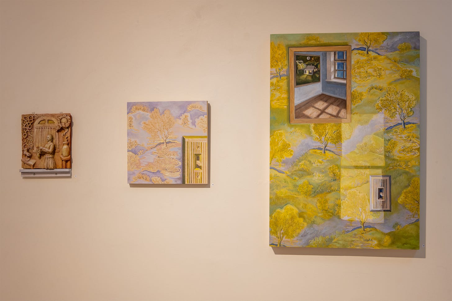 Three artworks on a wall, all created by Weinberg: the leftmost is a wooden sculpture with a man and a few surrealist plants, the middle is a painting of a purple wallpaper with a forest pattern and a light switch, the rightmost is a painting of a wall with a similar wallpaper to the middle, a lightswitch, and a painting. Bright light comes in through a window not shown.