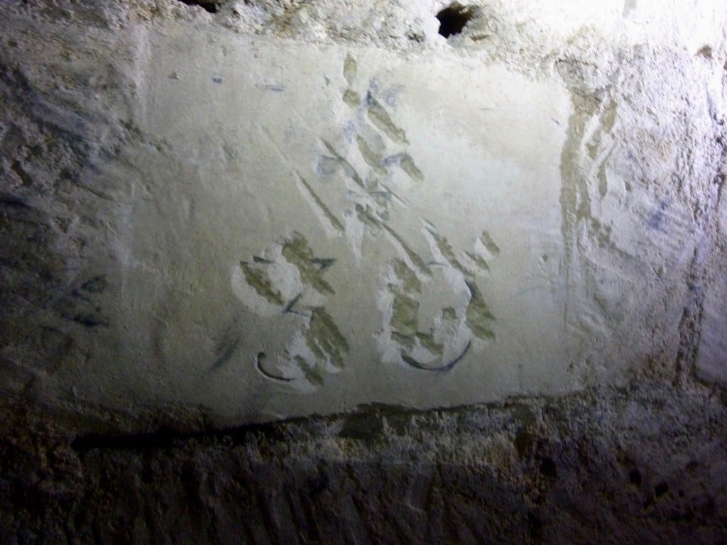 Scratched-out fleur-de-lys and number 30.