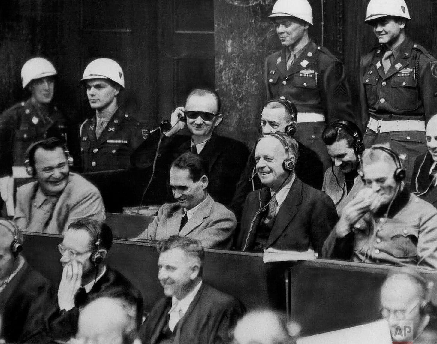 A shocking display of defiance: Hermann Goering, left, leads Nazi war criminals in laughter as evidence is presented during the Nuremberg Trials on November 30, 1945, a grim moment even the American guards observe with intrigue. A shocking display of defiance: Hermann Goering, left, leads Nazi war criminals in laughter as evidence is presented during the Nuremberg Trials on November 30, 1945, a grim moment even the American guards observe with intrigue.