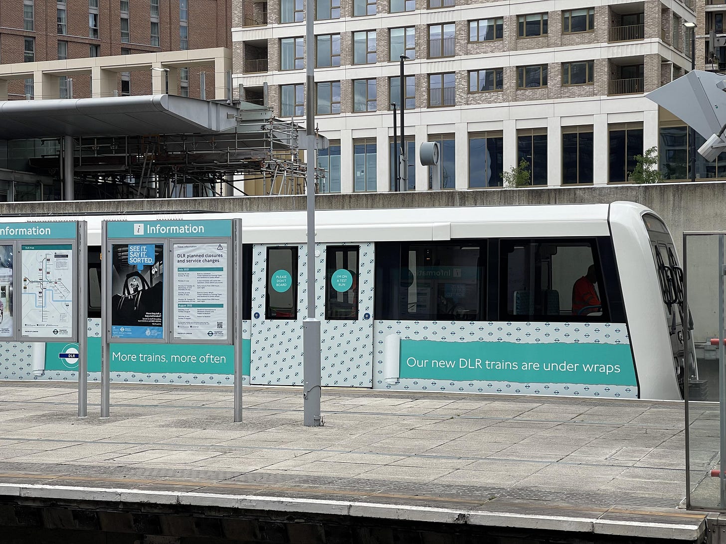 Photo of a new DLR train undergoing testing in custom testing livery.
