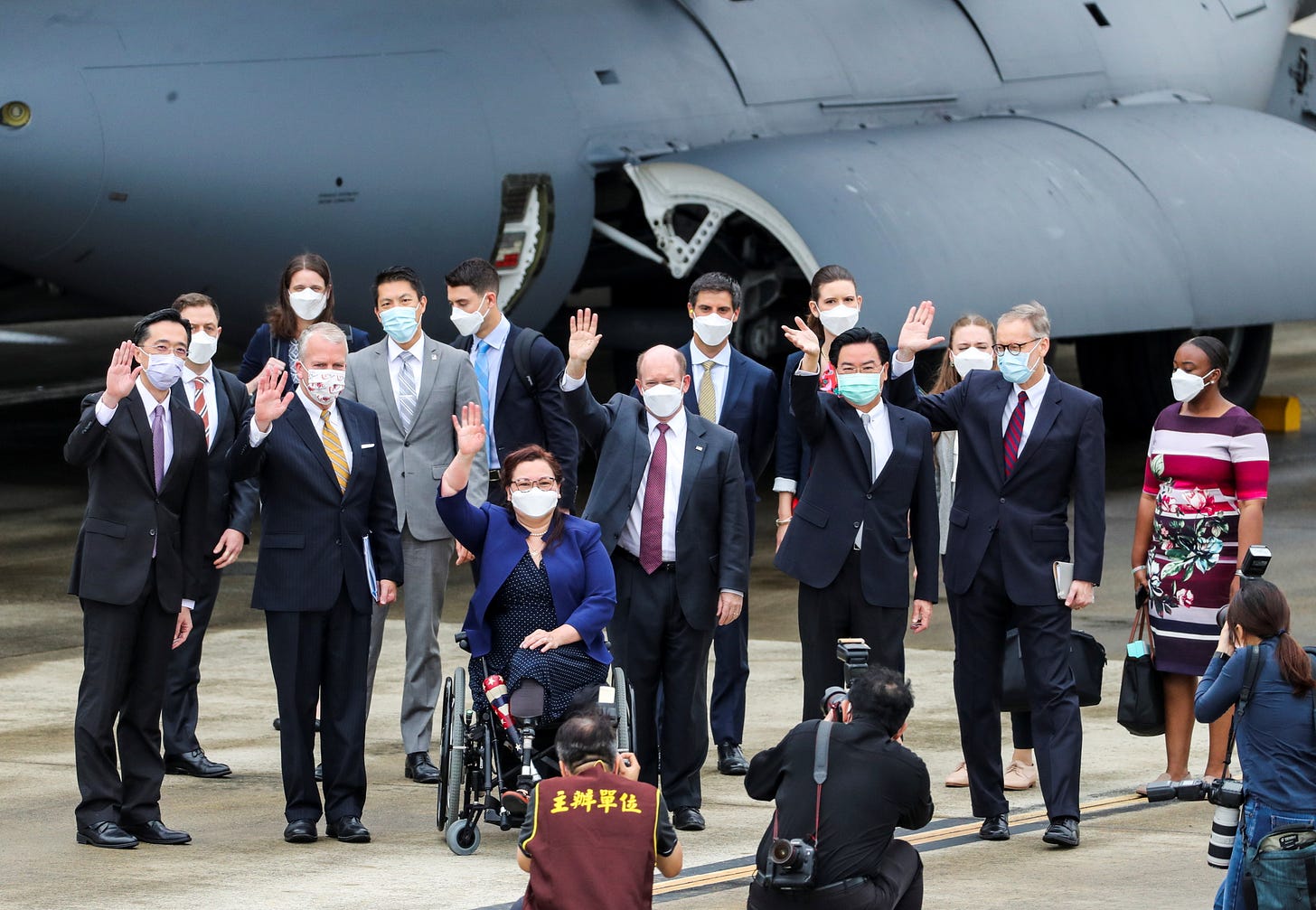 U.S. Senators Tammy Duckworth (D-IL), Dan Sullivan (R-AK) and Chris Coons (D-DE) wave next to Taiwan Foreign Minister Joseph Wu and Brent Christensen, director of the American Institute in Taiwan, after their arrival via a U.S. Air Force freighter at Taipei Songshan Airport in Taipei, Taiwan June 6, 2021. Central News Agency/Pool via REUTERS U.S. Senators Tammy Duckworth (D-IL), Dan Sullivan (R-AK) and Chris Coons (D-DE) wave next to Taiwan Foreign Minister Joseph Wu and Brent Christensen, director of the American Institute in Taiwan, after their arrival via a U.S. Air Force freighter at Taipei Songshan Airport in Taipei, Taiwan June 6, 2021. Central News Agency/Pool via REUTERS