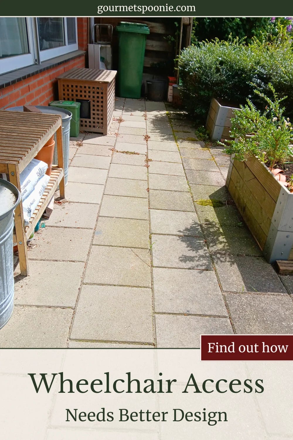 Long strip of paving running through a narrow urban garden with raised beds on one side.