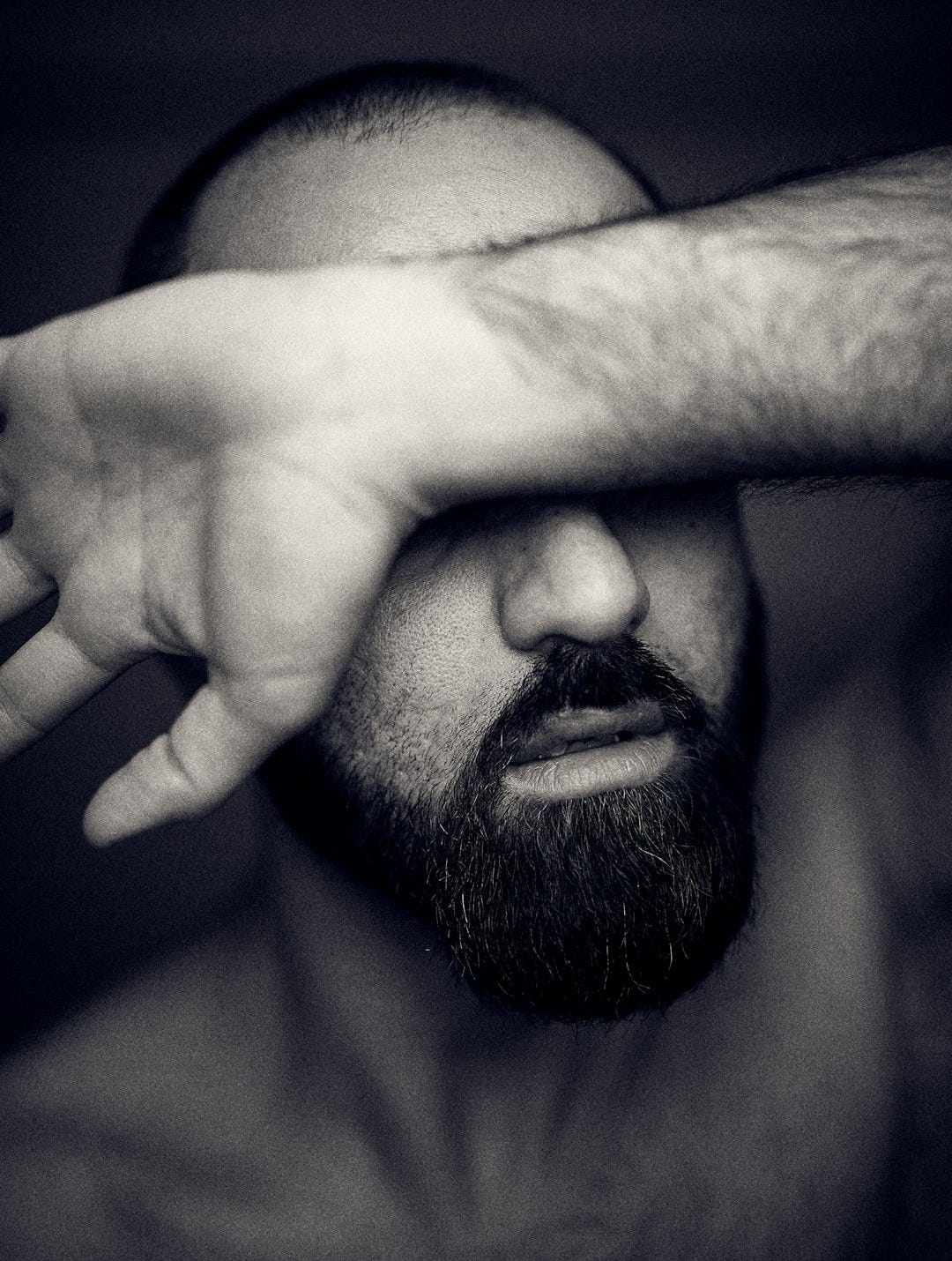 mans face in grayscale photography