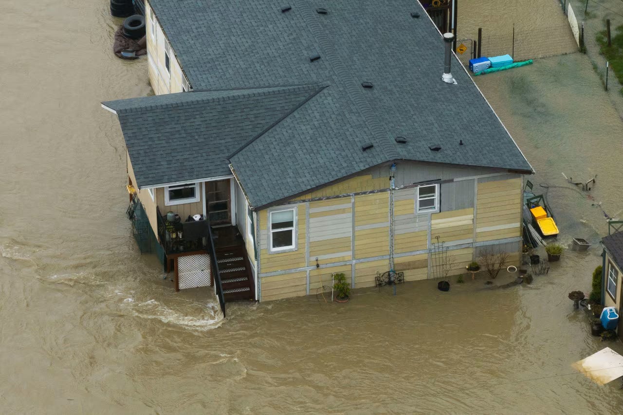 An aerial view shows a home flooded by the Wallace River in Gold Bar, Washington, on December 10.