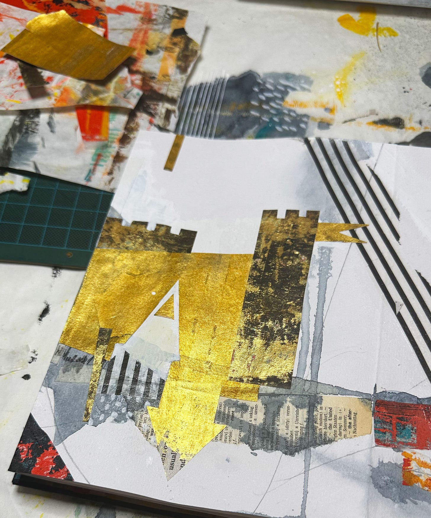 Sketchbook page showing a crude castle shape made of gold-painted papers