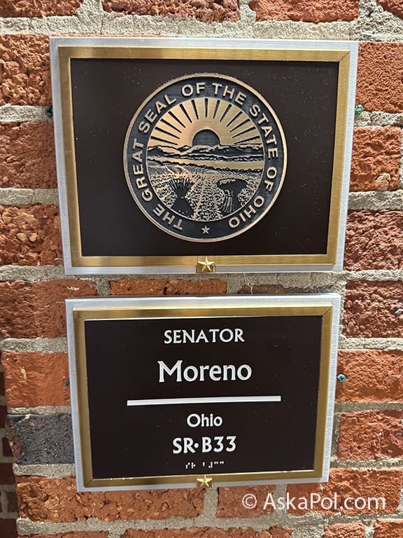 Ohio state seal and plaque for Sen. Bernie Morano hang on red brick wall Photo Matt Laslo © www.askapoldrugs.com