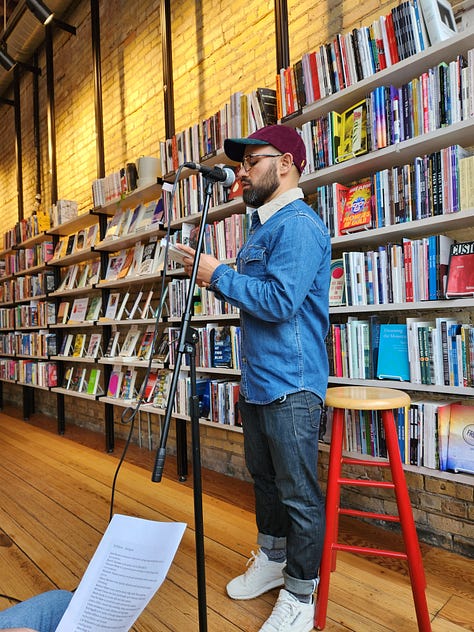 Various poets standing or sitting in Milkweed Bookstore, in front of filled bookcases, reading poetry.