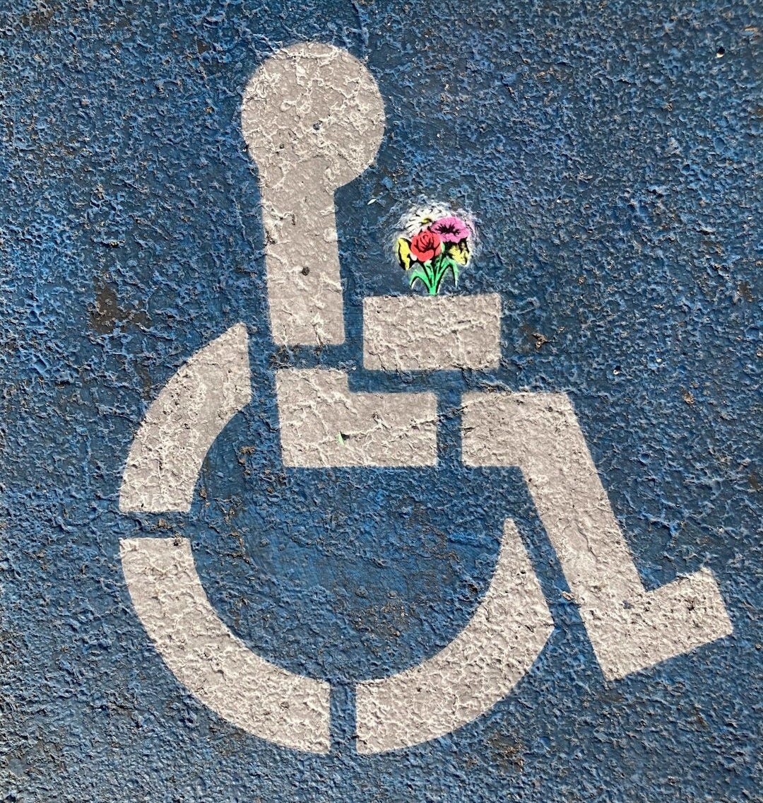 person in pink jacket standing on gray concrete pavement