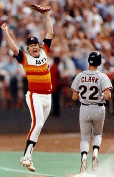 Mike Scott leaps in celebration after the Giants' Will Clark becomes the 27th out of Scott's division-clinching no-hitter.