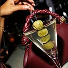 FOR THE LADY, PERHAPS A DRINK... AND A BAG?