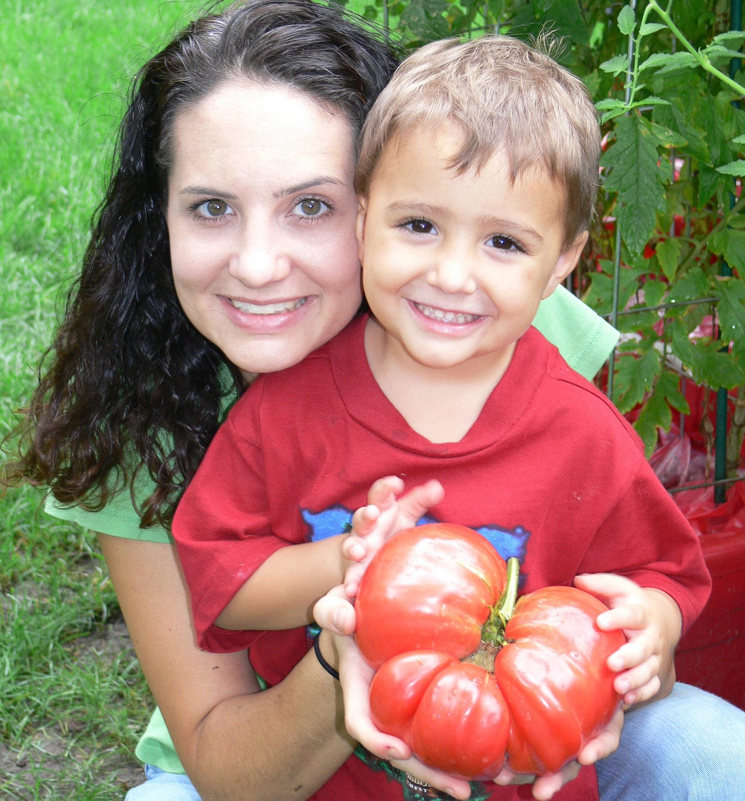 a kid and mom and a large tomato