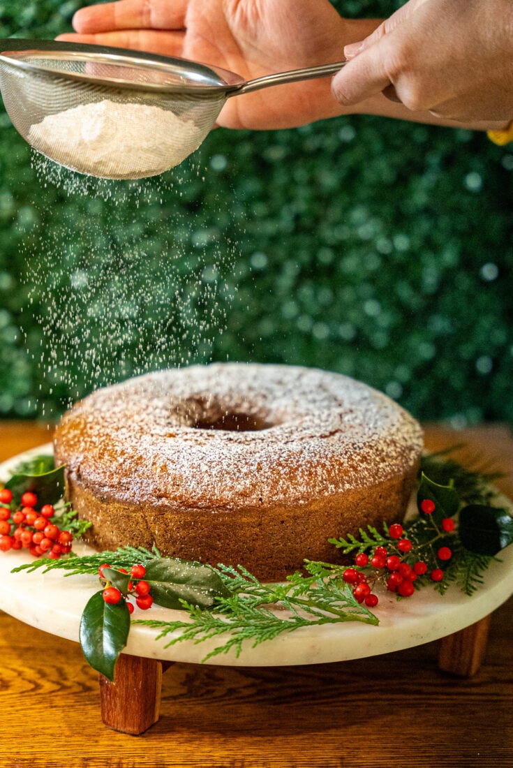 Dusting powdered sugar on a bunt cake