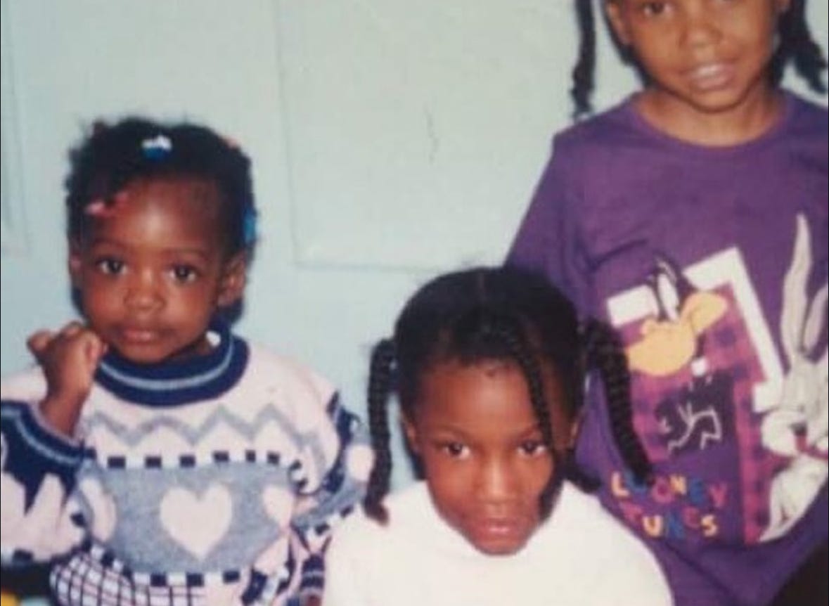 Three young Black girls. I am wearing a baby pink and navy blue sweater with hearts and various graphic designs. The girl in the middle wears a white turtle neck. The girl far right wears a purple Looney Toons t-shirt with Daffy Duck and Bugs Bunny on it. Three young Black girls. I am wearing a baby pink and navy blue sweater with hearts and various graphic designs. The girl in the middle wears a white turtle neck. The girl far right wears a purple Looney Toons t-shirt with Daffy Duck and Bugs Bunny on it.