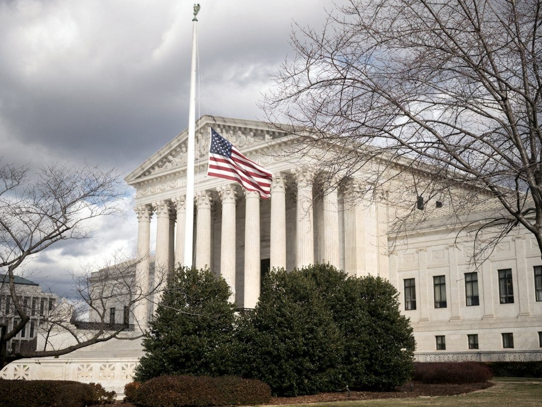 a large building with a flag on top of it