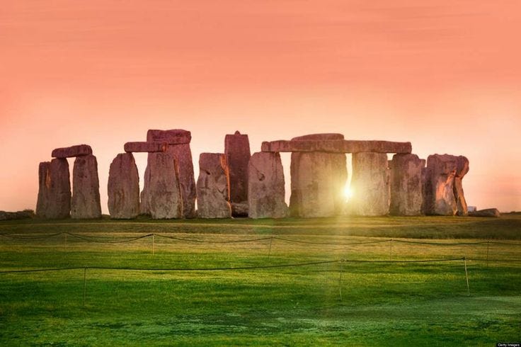 This may contain: the sun is setting over stonehenge in england's ancient city of stonehenge This may contain: the sun is setting over stonehenge in england's ancient city of stonehenge