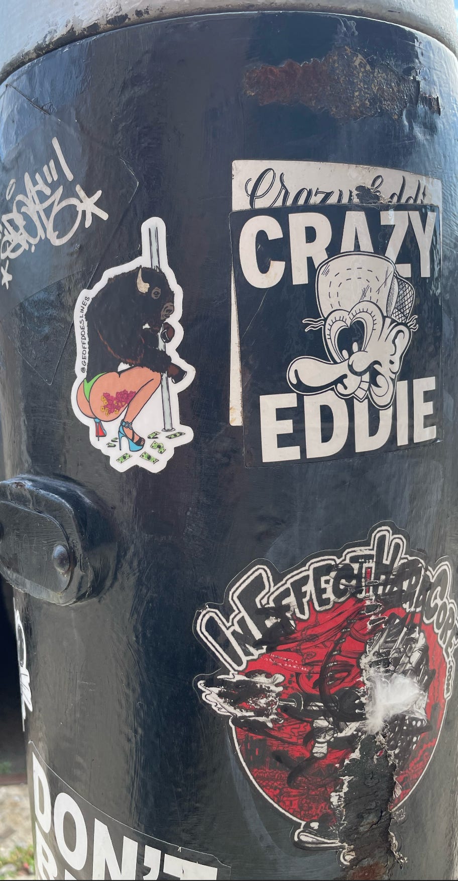 A fire hydrant with graffiti and stickers