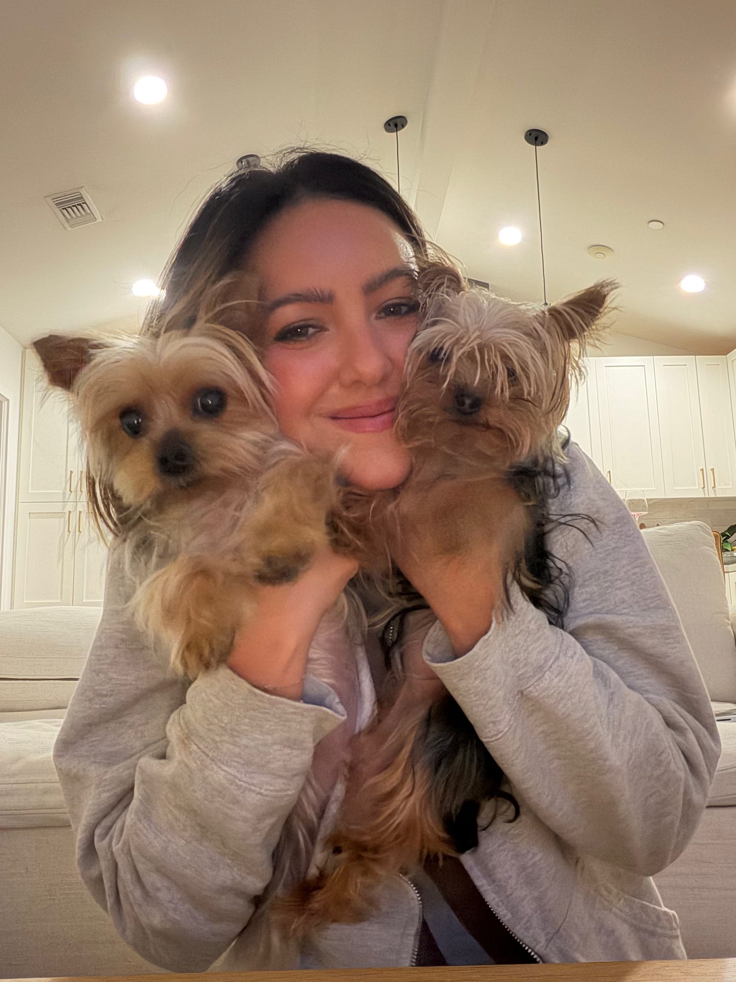 Erin O'Brien holding her two Yorkshire Terriers, Izzy & Luna.