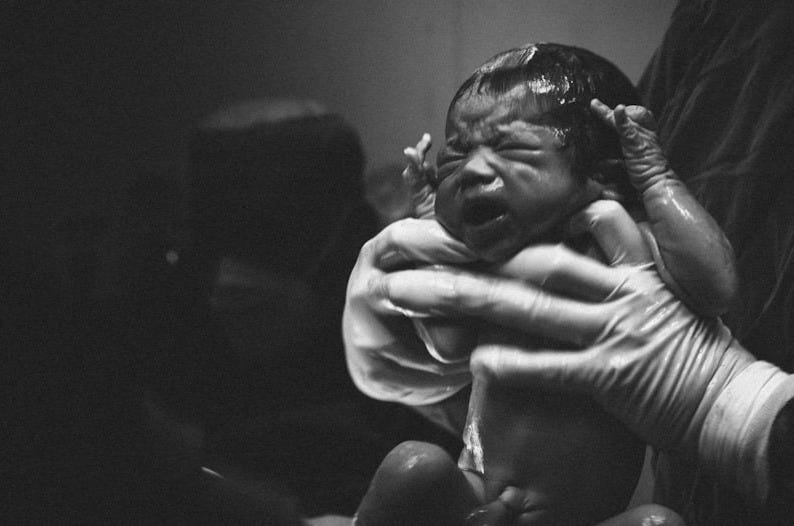 man and woman kissing grayscale photo